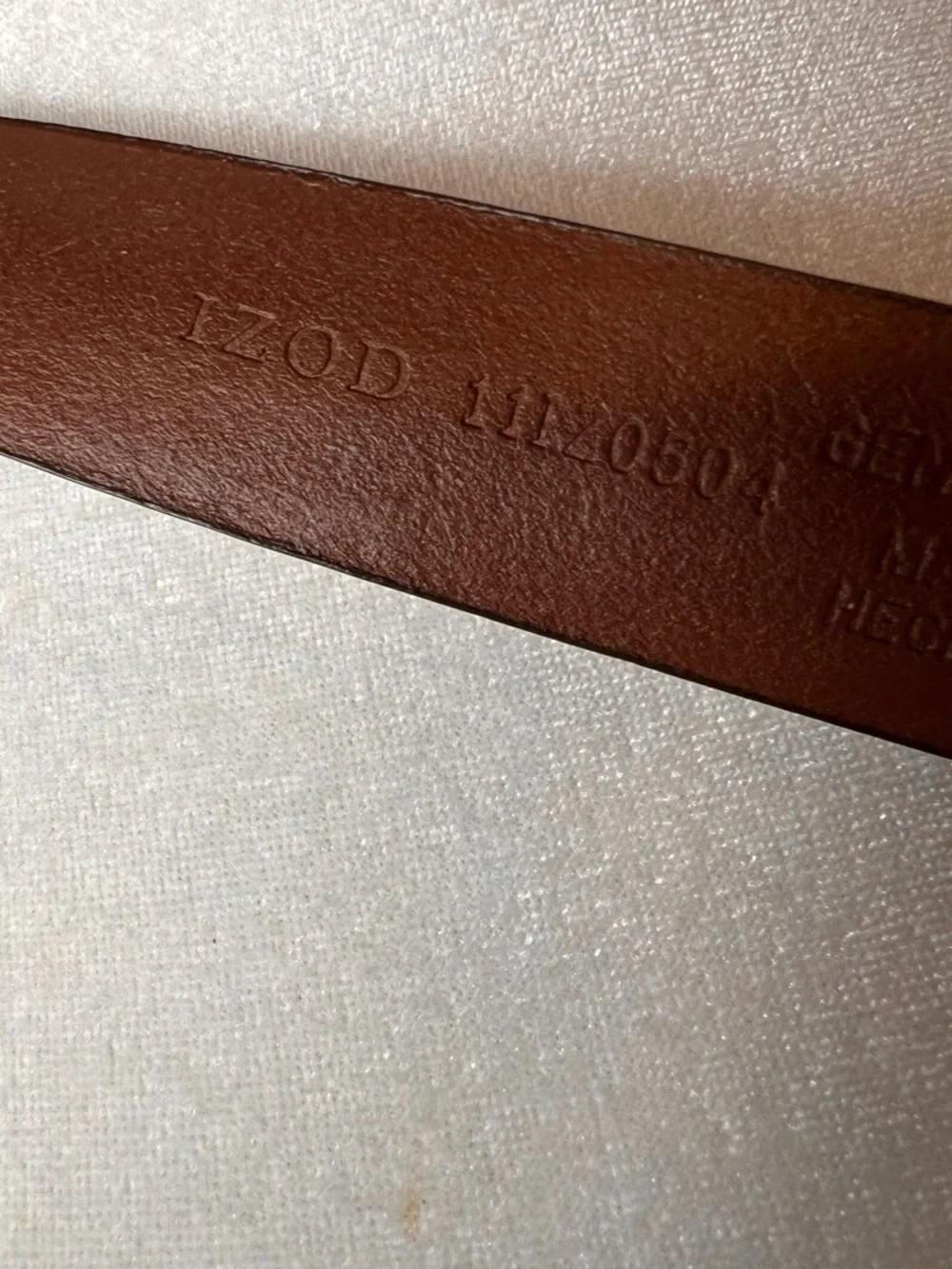 Izod Unique vintage genuine leather belt features a classic brown leather strap